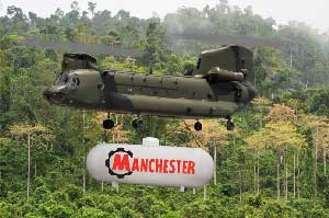 Military chopper carrying an above ground tank.
