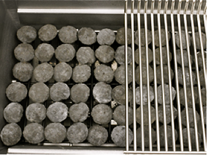 Barbecue briquettes on a briquette rack.