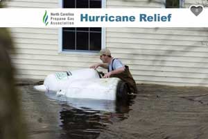 Man pushing tank through the flood water