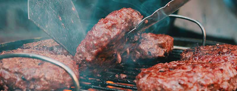 Steak on a portable barbecue grill.