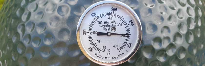 Close up of a Big Green Egg thermometer.